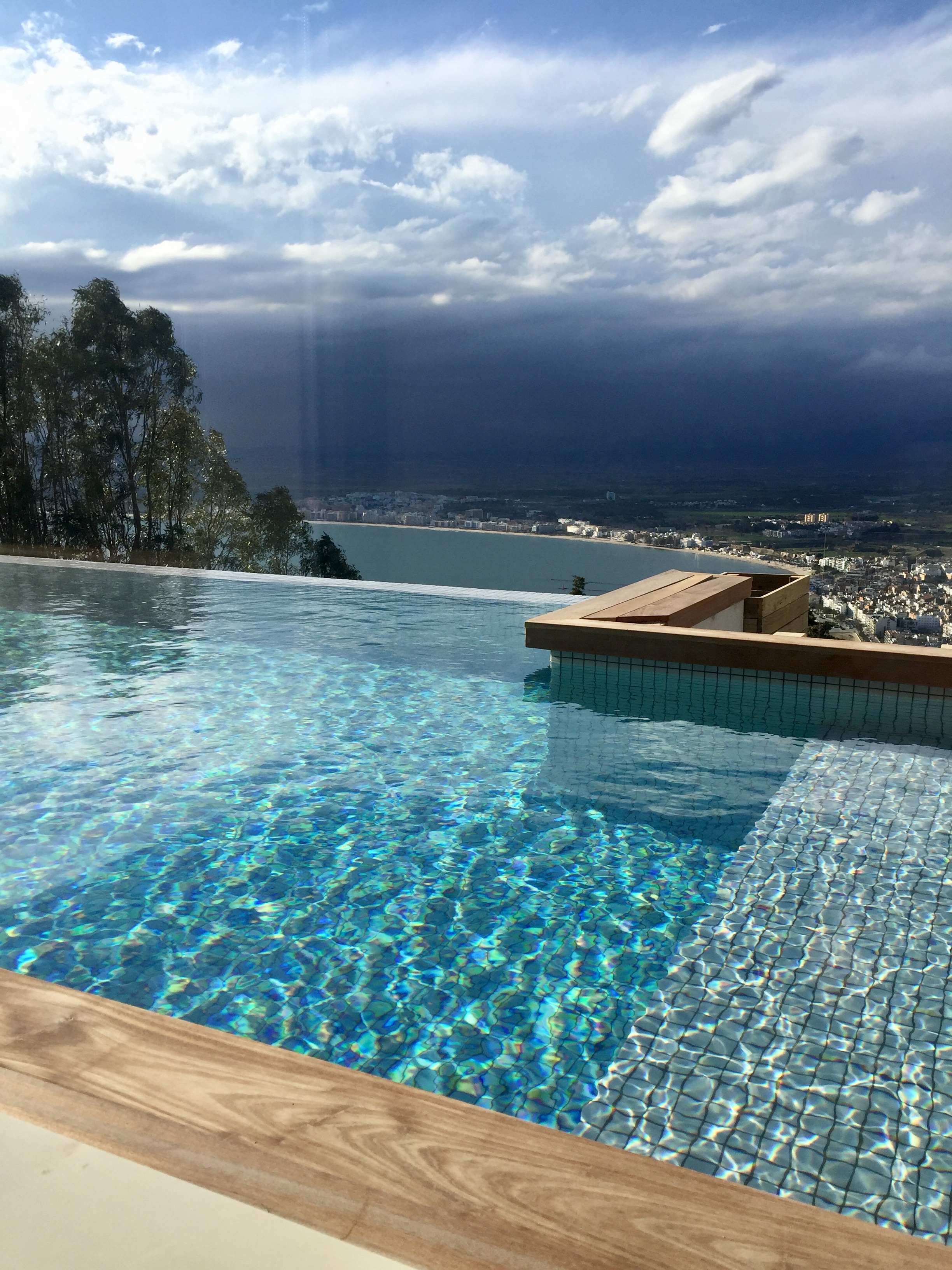 Infinity pool under dramatic storm clouds